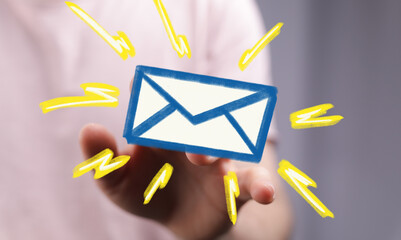 Poster - Hand holding a digital email icon with bright yellow lighting effects.  Perfect for communication concepts.