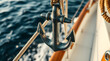 © Abdulloh - Metal anchor hanging on a sailboat on the sea during a sunny day