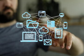 Fototapete - A man interacts with a visual representation of a cloud computing network, showcasing data connectivity and digital devices.