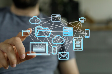 Poster - Stock photo of a person interacting with a digital network showing cloud storage, devices, and data transfer.