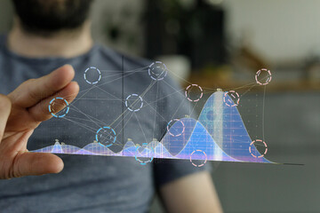 Aufkleber - Stock photo of a man interacting with a holographic display showing data charts and graphs.
