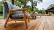 © lililia - Modern wooden terrace showcases stylish black rattan armchairs, soft blanket, lanterns, and lush plants in a serene summer evening setting