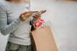 © Witoon - A person in jeans and a long-sleeved shirt carries several colorful shopping bags, likely after a shopping trip.