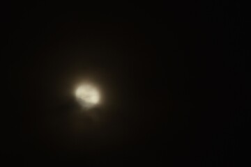 Wall Mural - blurry full moon covering by cloud floating on sky in night background