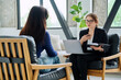 © Valerii Honcharuk - Female journalist, employer interviewing working with woman sitting together in office