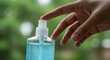 © Rex - A person's hand is shown pressing the top of a clear plastic spray bottle filled with blue liquid