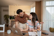 © Migma_Agency - Happy couple smiling and using laptop at home for finances