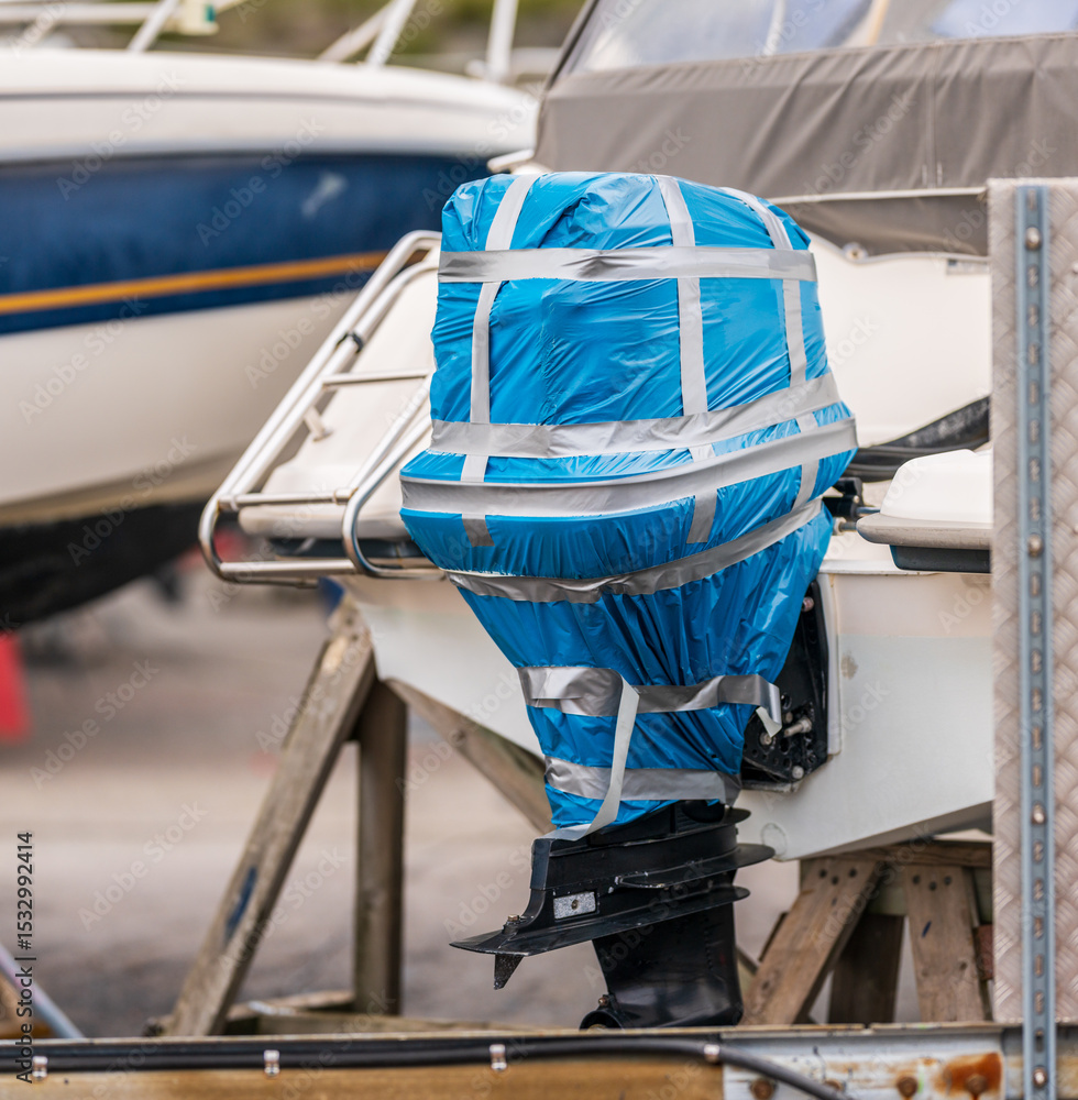 Wrapped outboard engine on boat prepared for storage. Stock Photo ...