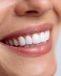 © rinrada - Close-up of a smiling woman showing perfectly white, clean teeth.