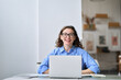 © insta_photos - Portrait of young happy business woman company employee sitting at desk working on laptop. Smiling female professional designer or student using computer in corporate office looking at camera.