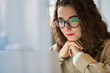 © insta_photos - Busy professional business woman employee using laptop watching online webinar or training web course. Young serious student wearing glasses looking at computer, thinking, elearning, doing research.