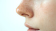 © Marut - Soft focus close up of side profile showing nose and upper lip with natural freckles on smooth skin, highlighting delicate facial features and gentle expression