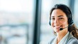 © sukarman - young female call center agent wearing headset with confident smile, concept for customer support service with copy space