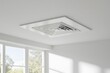 © Jim - Ceiling mounted duct fan with air vent for bathrooms or kitchens to remove humidity and odors, Plastic grille for air conditioning vents on the ceiling, a white square ceiling vent, modern design.