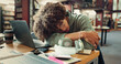 © peopleimages.com - Tired, man and student sleeping in library with burnout for studying with university test. Fatigue, education and person with afternoon nap for resting at desk laptop at college campus for exhaustion