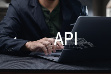 man using laptop to develop programming interface with api concept