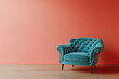 © Trendy Motion - Turquoise Velvet Armchair Against Salmon Wall in Room with Wooden Floors and Black Legs