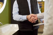 © Studio Romantic - Close-up of salesman shaking hands with client in plumbing store, confirming purchase for home water needs, focusing on hardware renovation in a professional setting with agreement.