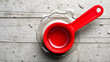 © Cynthia - Top view of red plastic water ladle