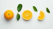 © Ramsha - A flat lay of oranges whole half and sliced with green leaves on a white background studio shot