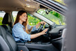 © wedmoments.stock - A confident young woman driving a car. Test-driving a new car or traveling.