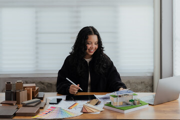 a happy and successful female architect smiling confidently while working on her project in a modern