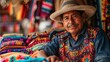 © S photographer - A smiling artisan wearing traditional attire, surrounded by vibrant textile crafts in a lively market atmosphere.