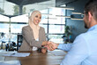 © Stock 4 You - Young muslim bank worker woman in hijab shaking hand with client, hr manager welcome recruit employee. Middle eastern arab businesswoman showing greeting after signing contract with business partner