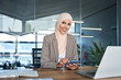 © Stock 4 You - Middle Eastern muslim businesswoman manager ceo using cell phone mobile app. Smiling young indian woman in hijab holding smartphone sitting in office working online. Portrait looking at camera