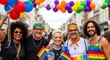 © Zanzaa - Group of happy people celebrating Pride holding LGBTQ flags.