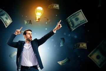 Wall Mural - excited businessman pointing at glowing lightbulb symbolizing idea and success, surrounded by flying