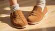 © Виктория Исаева - Casual footwear with brown slip-on shoes and cozy socks indoors