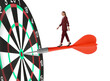 © New Africa - Concepts of targeting, decision and goal achievement. Businesswoman walking on dart sticking in center of dartboard against white background