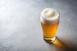 © Introvertia - Pint of lager beer with thick foam on grey surface offering refreshing drink experience