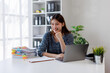 © David - Image of happy young Asian business woman working document and laptop at office