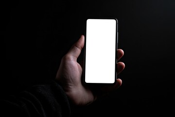 Sharp Picture of a Hand Holding a Smartphone Isolated on a Black Background