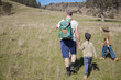 © Austockphoto - Dad and two young sons bushwalking through a paddock