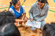 © unai - Female basketball coach explains game strategy to team