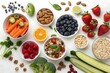 © ARTSPRIO - Variety of fruits and vegetables are displayed in bowls on a white table