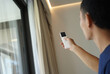 © romaset - Worker checking Automatic curtain control system in apartments