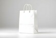 © Mahmuda - Blank White Paper Shopping Bag Mockup on Clean Floor – Minimalist Retail Packaging Presentation