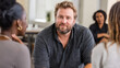 © ALA - A man with obesity attending a support group, engaging in a conversation about health goals