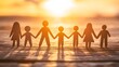 © Farid - Silhouette family figures linked together at sunset.