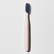 © LELISAT - A side view of a mockup showcasing a beige toothbrush with blue bristles is used to advertise products related to oral hygiene