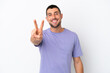 © luismolinero - Young handsome caucasian man isolated on white background smiling and showing victory sign