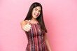 © luismolinero - Young Brazilian woman isolated on pink background with thumbs up because something good has happened