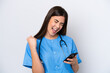 © luismolinero - Young Brazilian nurse woman isolated on white background with phone in victory position