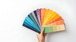 © Cathy - Female hand holding color samples on white background