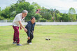 © Verin - asian senior couple petanque practice on green grasses in sport stadium,elderly lifestyle,workout,athlete,sport,recreation,relaxation