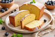 © DruZhi Art - Homemade Plum Cake with Blueberries – Sliced Pound Cake on Wooden Plate for International Cake Day Celebrations, Bakery Blogs, and Homemade Dessert Inspiration